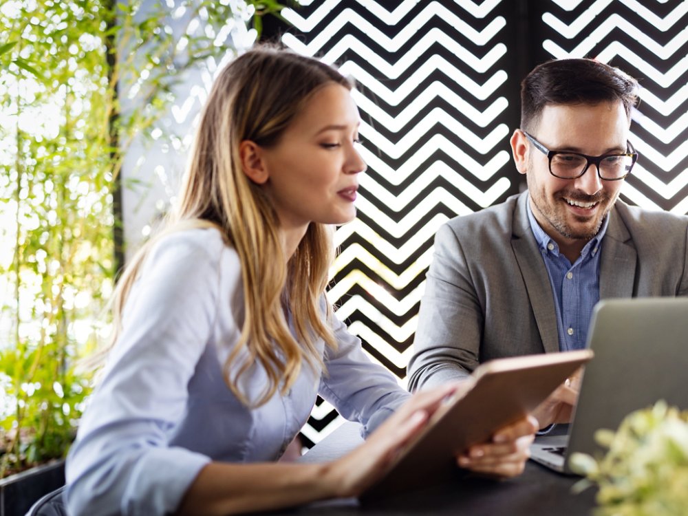 Happy business colleagues at meeting in modern office interior
