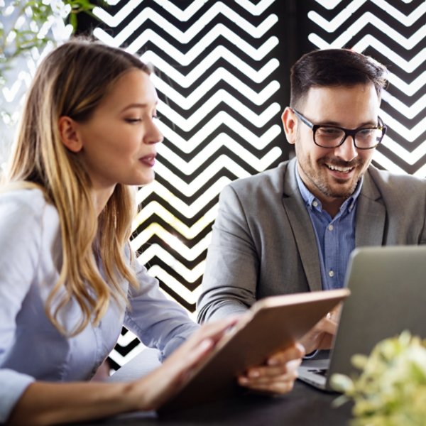 Happy business colleagues at meeting in modern office interior