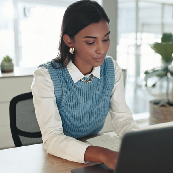 Accounting, finance and laptop with business Indian woman at desk in office for bookkeeping report. Computer, research and typing with professional accountant in workplace for financial management.