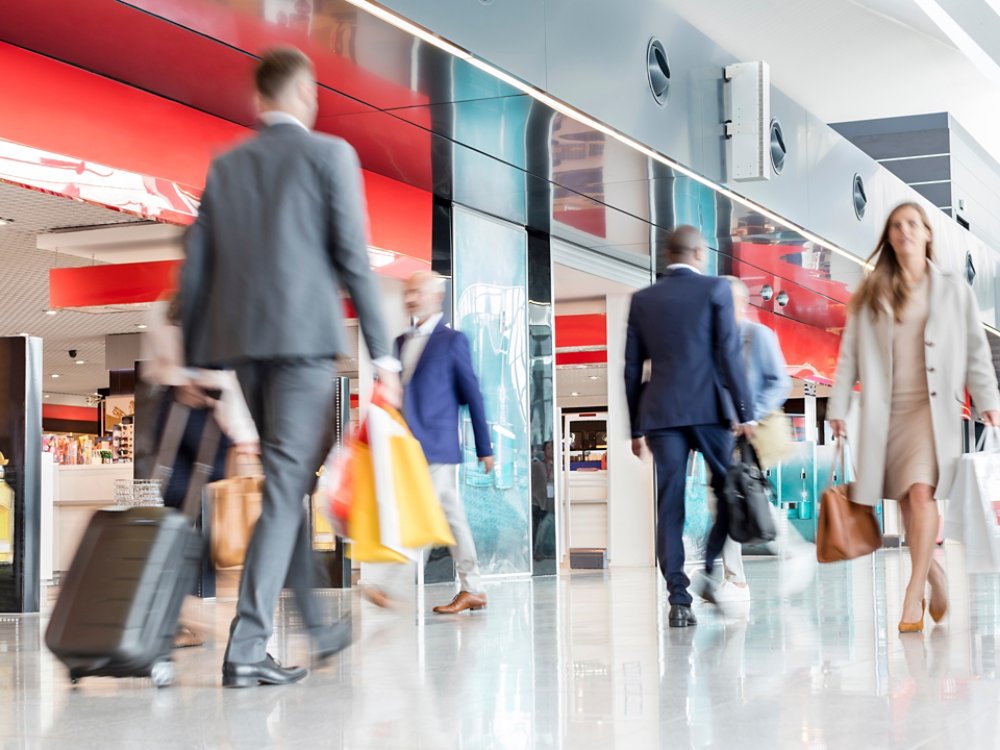 Travelers walking in airport concourse