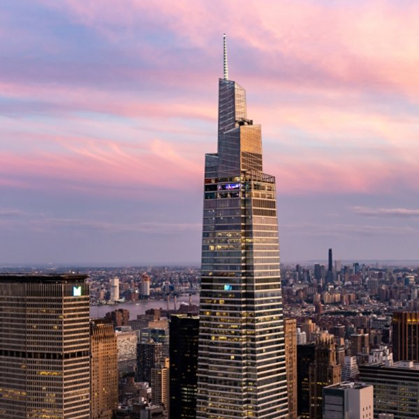 Aerial View of One Vanderbilt Met Life Building NYC Skyline with pink skies and clouds.