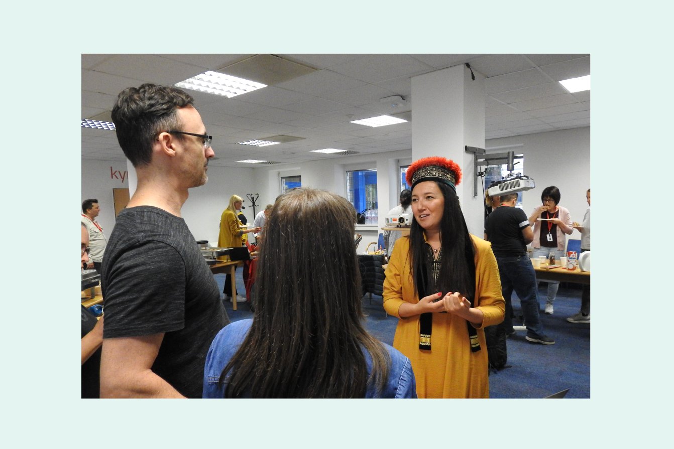 A diverse group of people is working on a project as a team building volunteer activity