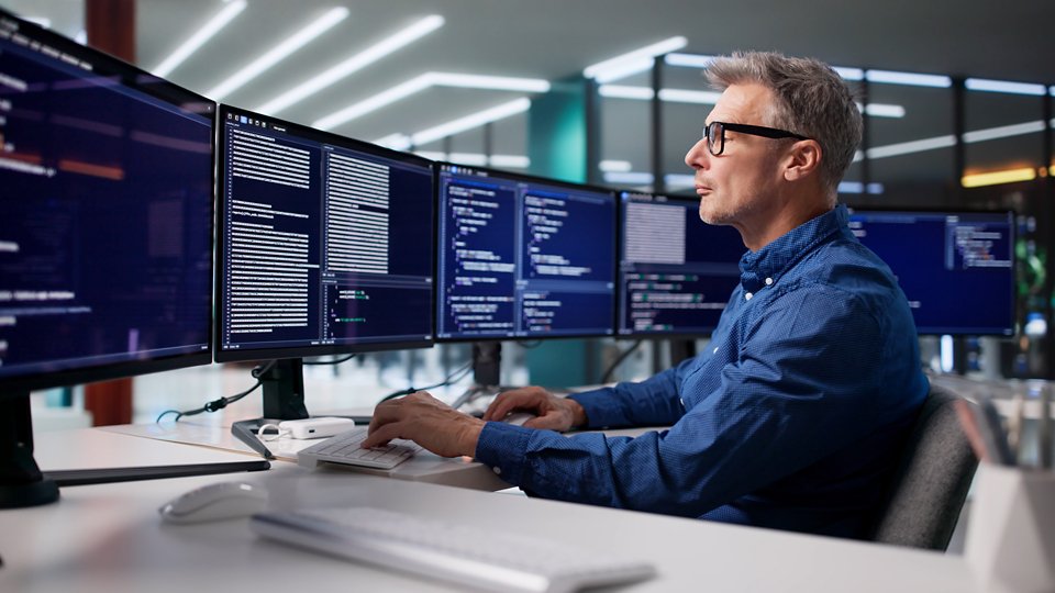 Focused Programmer Develops Cyber Security Software For Business In Office