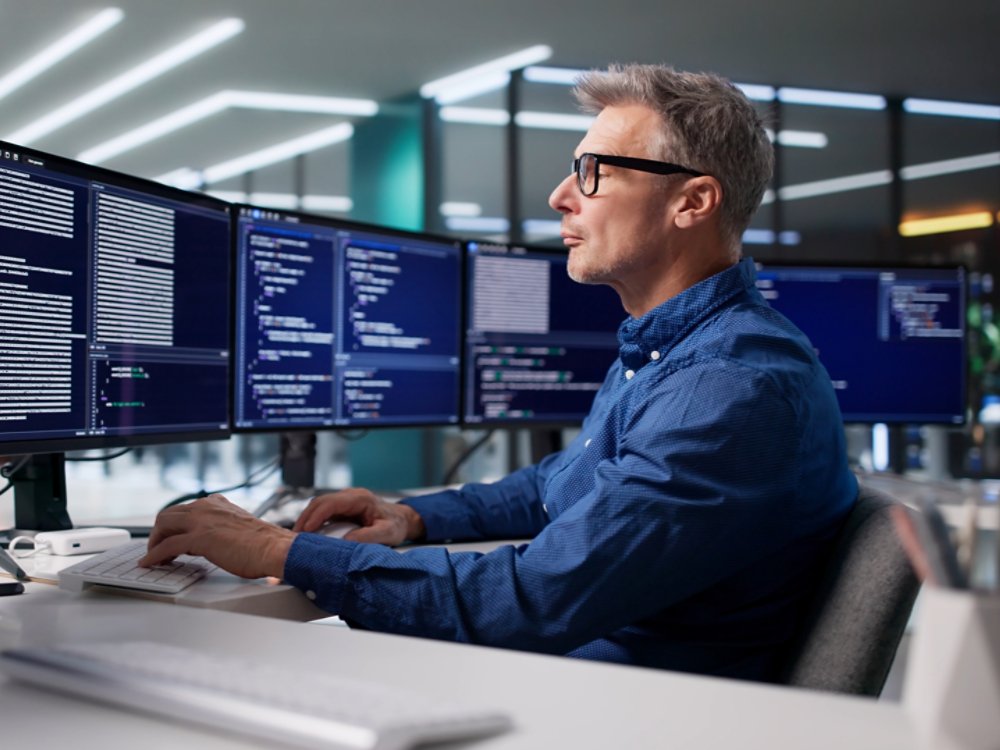 Focused Programmer Develops Cyber Security Software For Business In Office