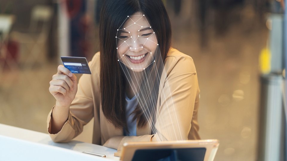 Asian women using the technology tablet for access control by face recognition in private identification step when online shopping with the credit card, credit card mockup, online payment concept,