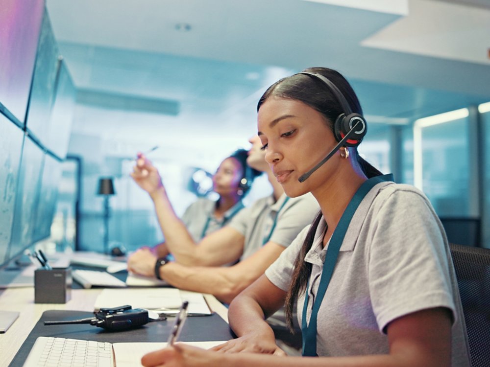 Computer, emergency service and woman with headset for security, dispatcher and operator. Telecommunication, surveillance office and first responder with monitor for incident report, contact and help.