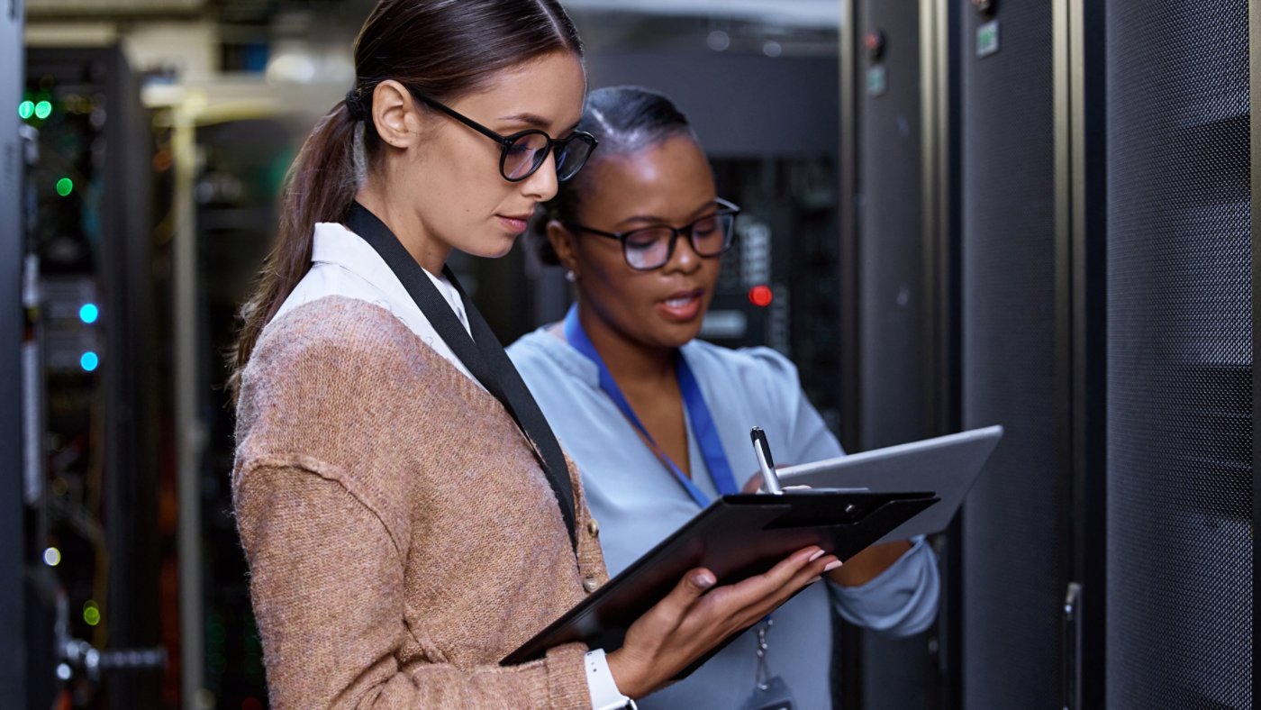 Cropped shot of two attractive young female computer programmers working together in a server room.