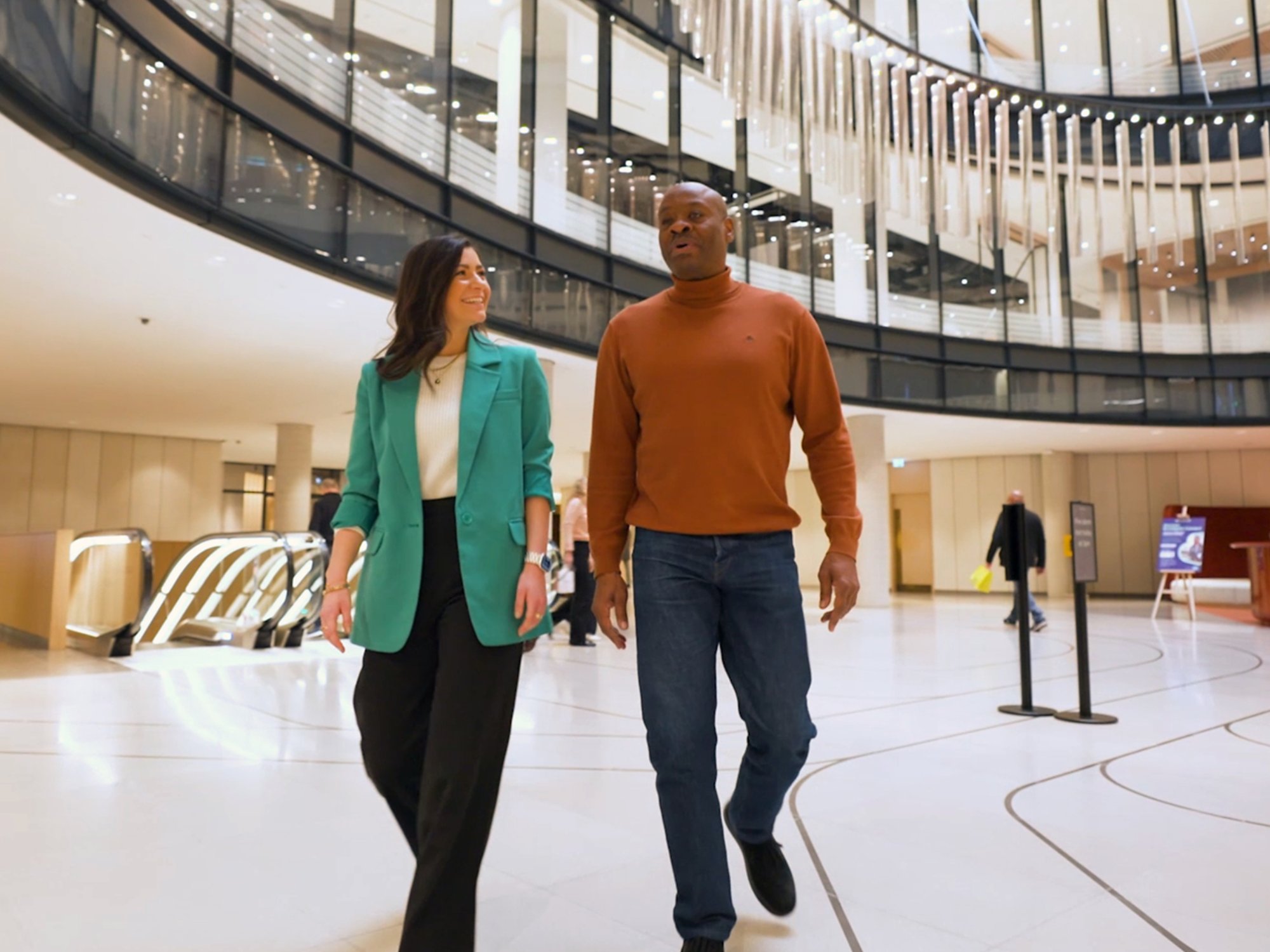 2 kyndryl employees from the UK walking through the office building
