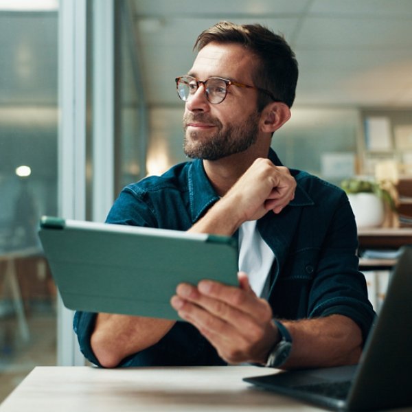 Tablet, thinking and smile with business man in office for planning, ui designer and app review. Developer solutions, reflection and research with person in agency for project idea and startup.