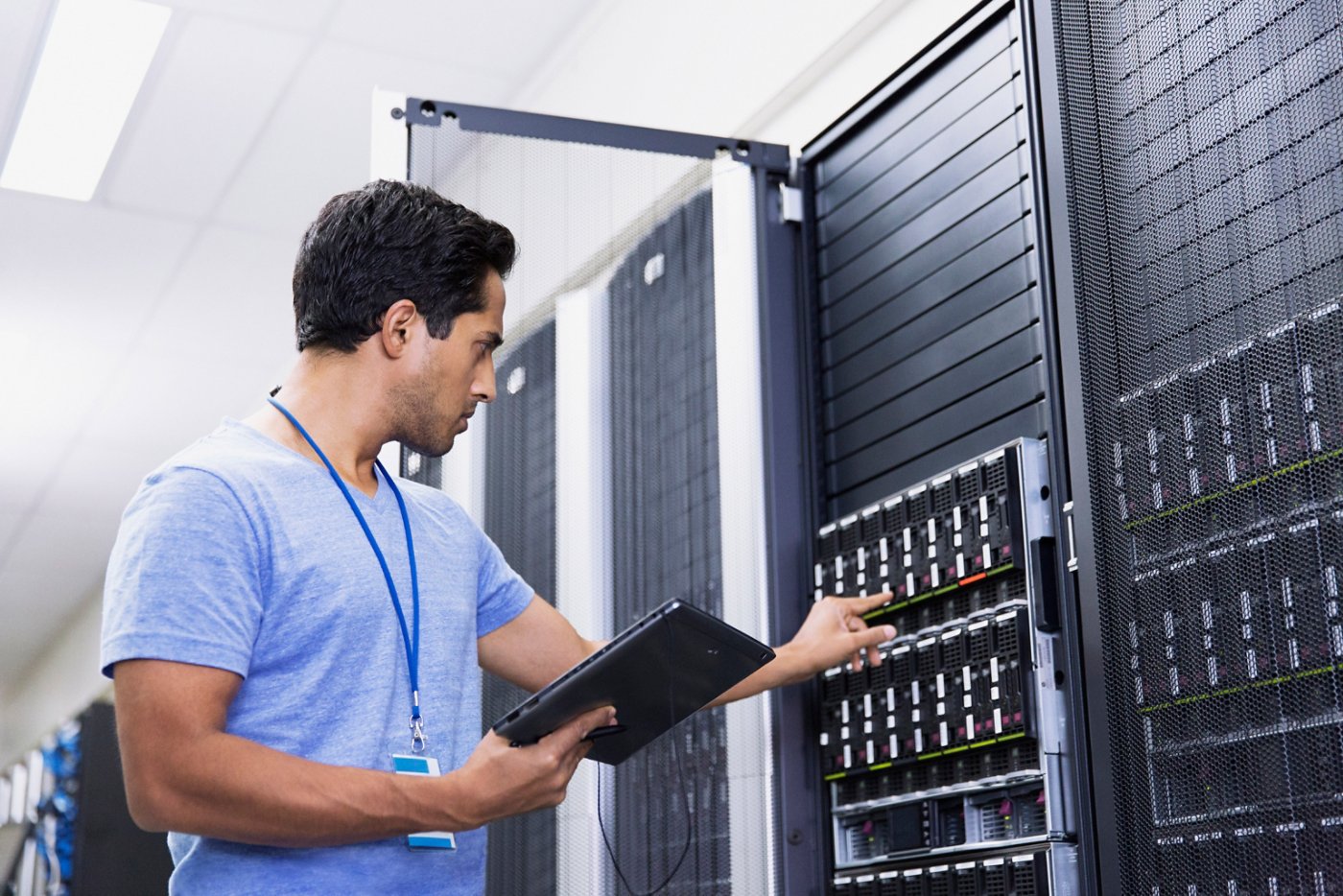 IT worker with iPad in server room