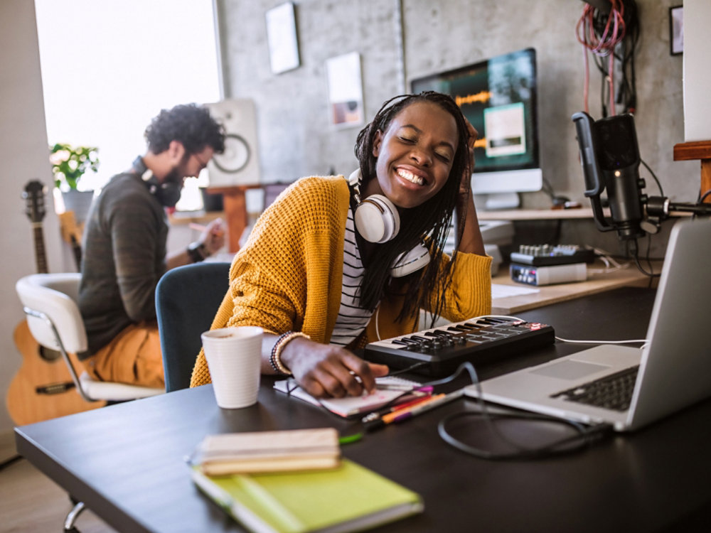 girl with headphones sitting on a computer and enjoying 4X3