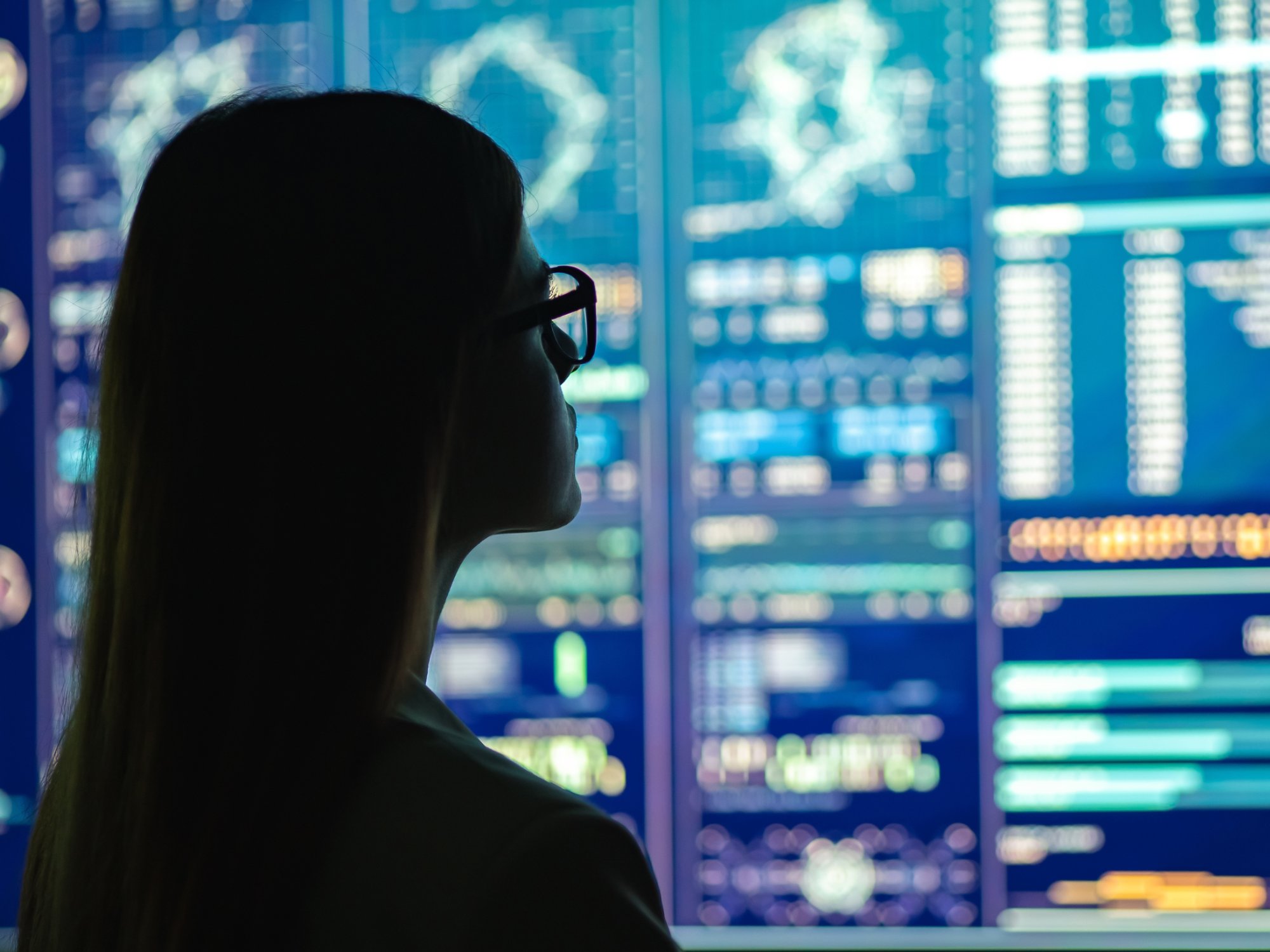 An IT professional is real-time monitoring the overall system status of her company's IT estate.
