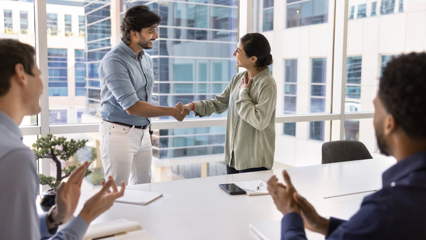 Promoting talent. Smiling mature male business team leader ceo boss handshaking with happy millennial female worker manager praise for work acknowledge professional success before applauding teammates