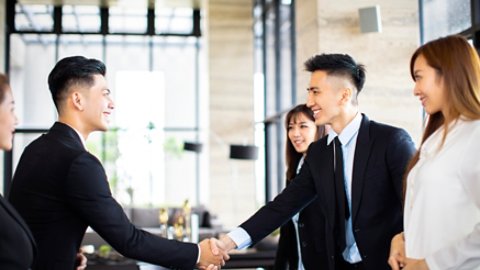 Young business people shaking hands in the office