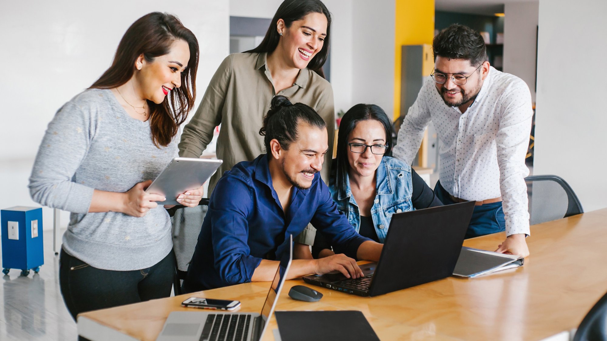 Group of latin business people working together as a teamwork while sitting at the office desk in a creative office in Mexico city