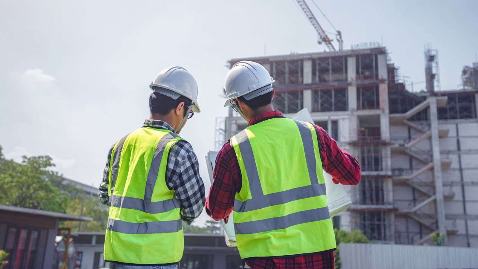 engineers discussion with consultants about detail of building at construction site