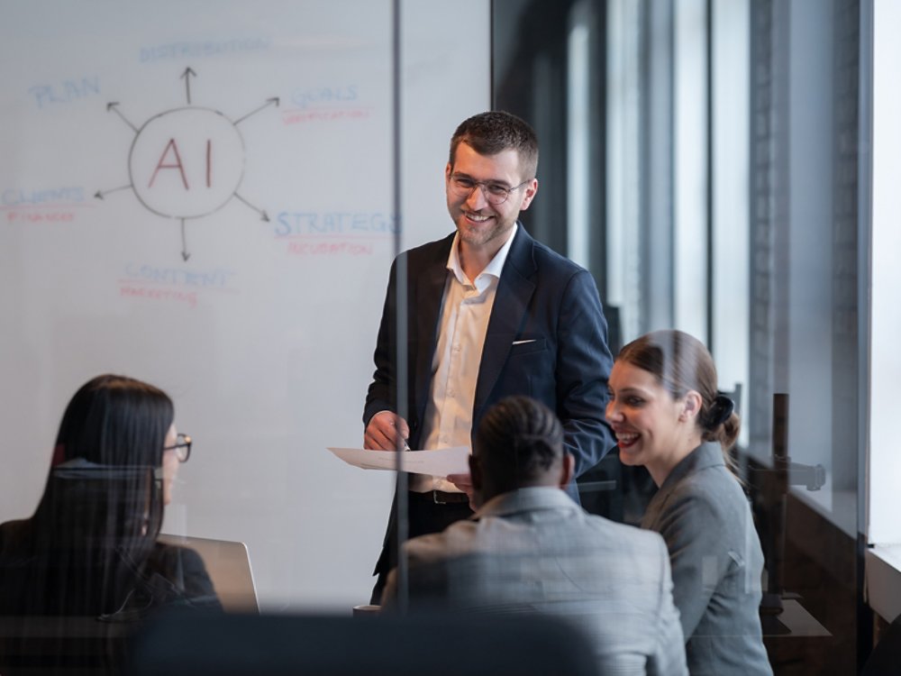 Diverse business team in a modern office during a meeting, discussing artificial intelligence strategy. Concept of AI innovation, teamwork, leadership, corporate planning, professional collaboration.