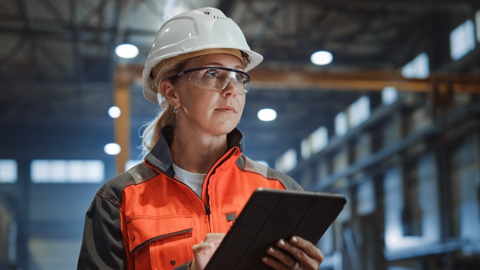 Woman in hard hat with tablet