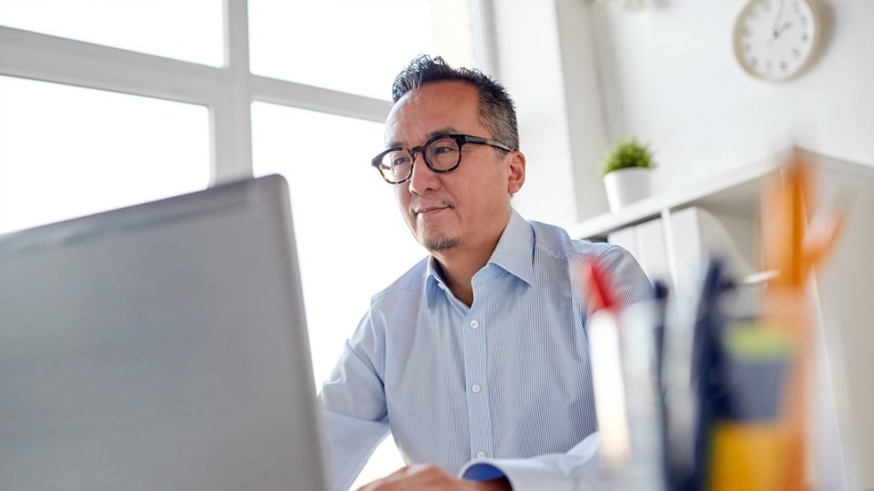 Japanese man working at a computer