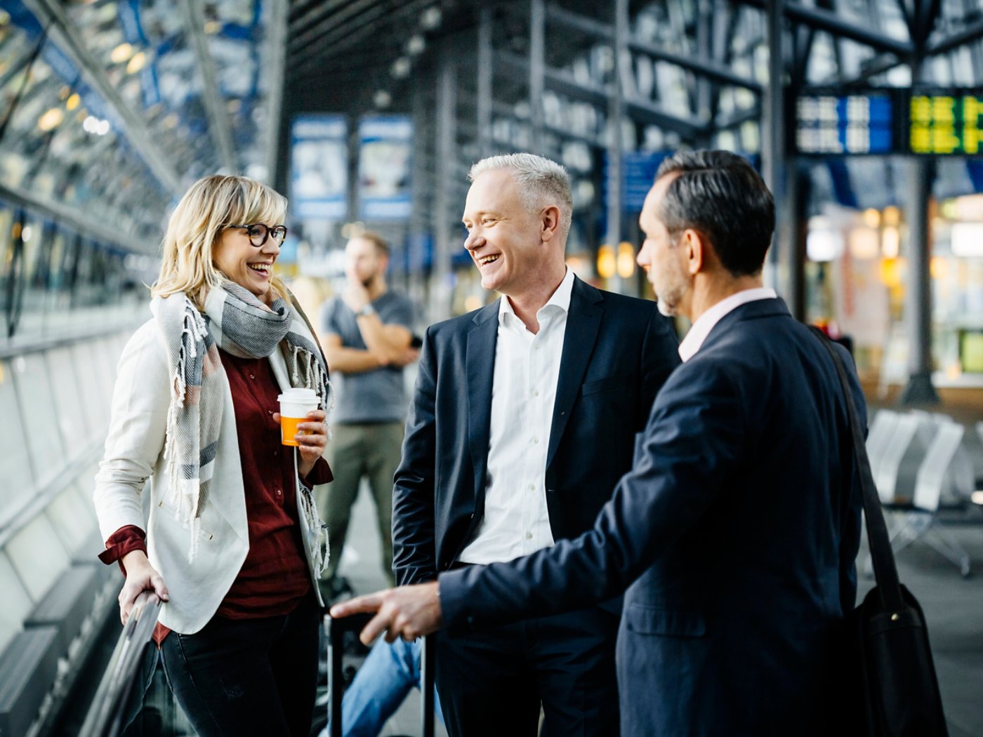 Three business traveler at Airport talking together