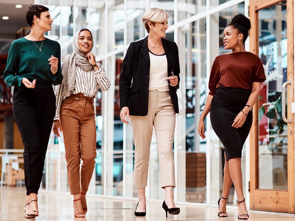 Shot of a group of businesswomen walking alongside each other in an office