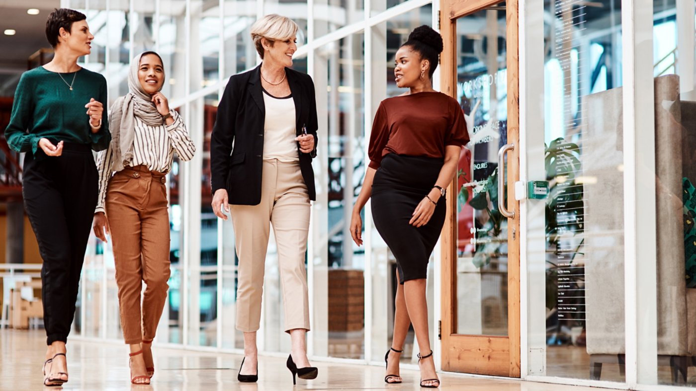 Shot of a group of businesswomen walking alongside each other in an office