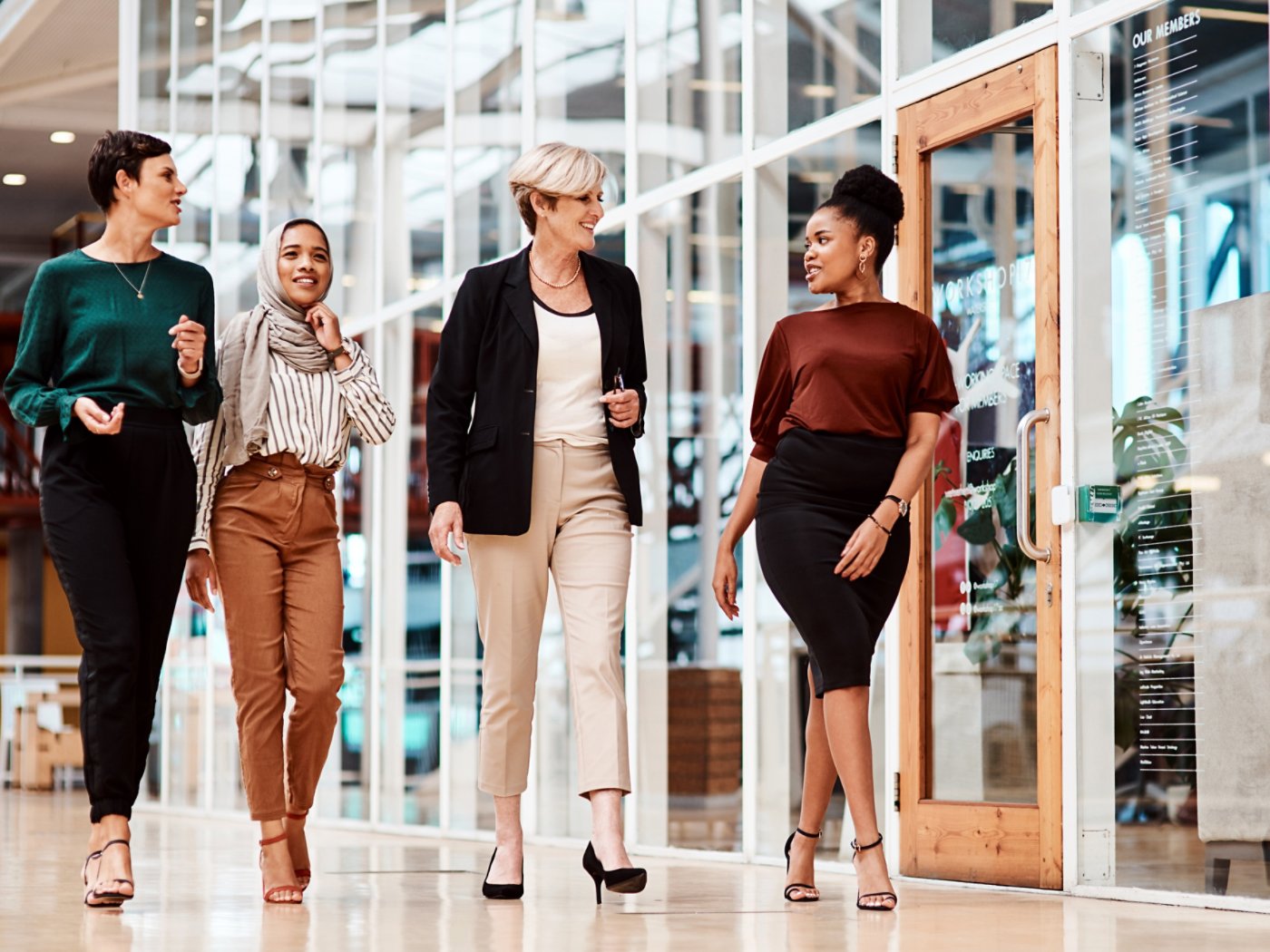 Shot of a group of businesswomen walking alongside each other in an office