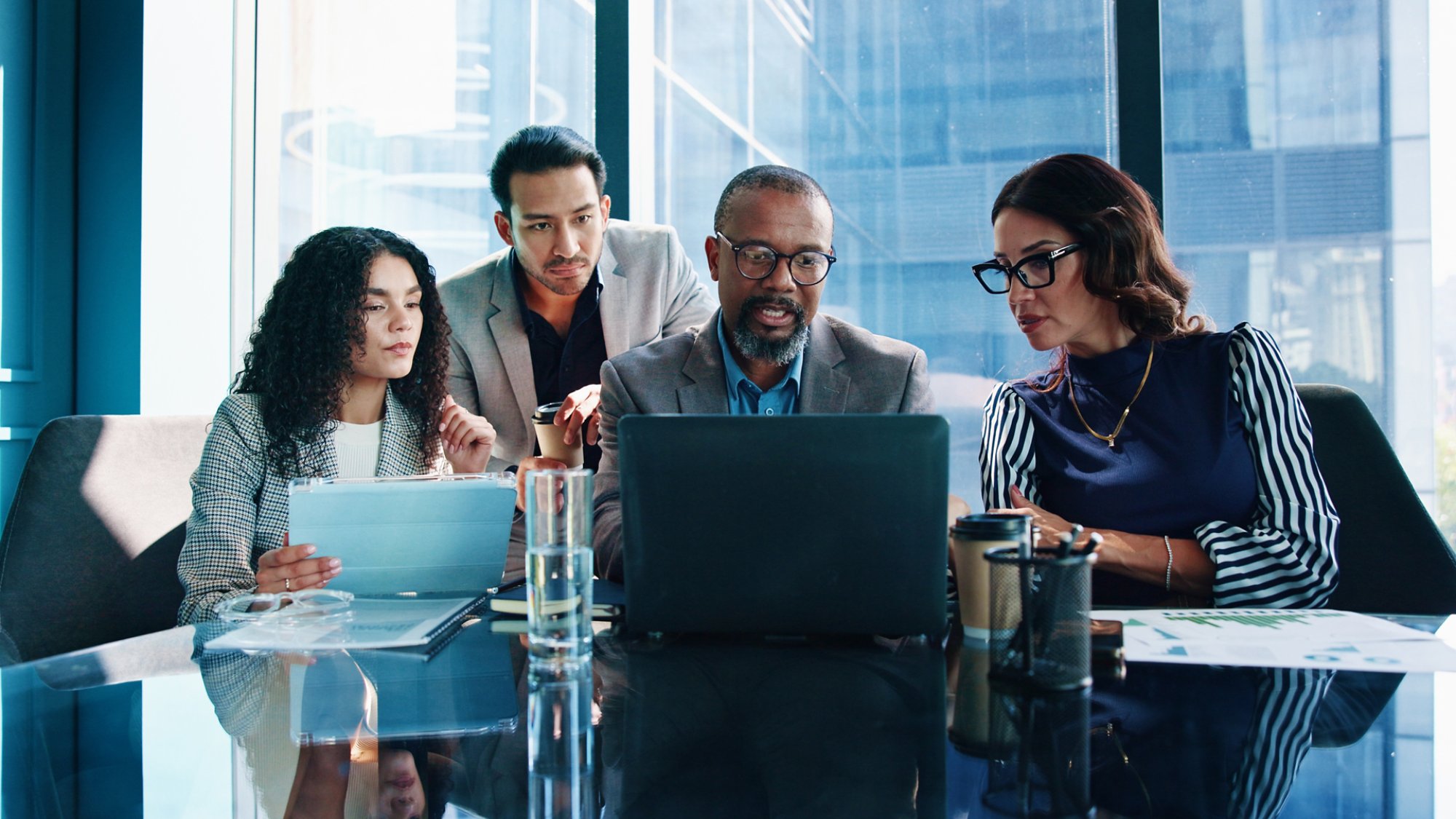 Laptop, team and business people planning in meeting or brainstorming idea with investment data. Group, computer or corporate discussion with risk manager for analysis or financial proposal in office.