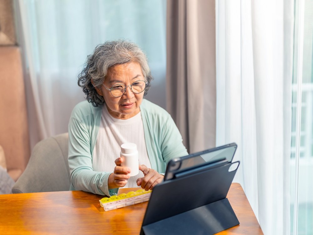 Asian senior woman video call with doctor on digital tablet