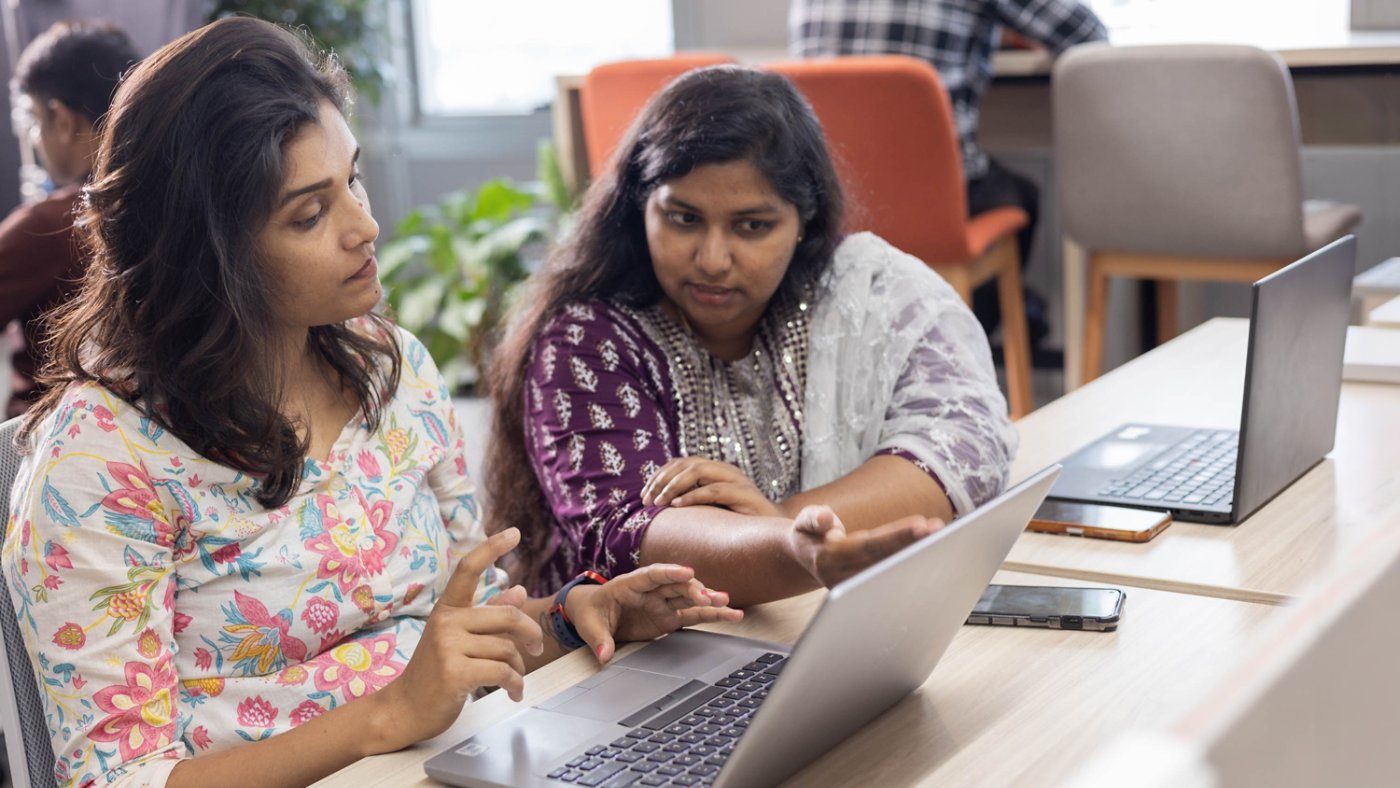 Two Kyndryl technology employees from India discussing a project