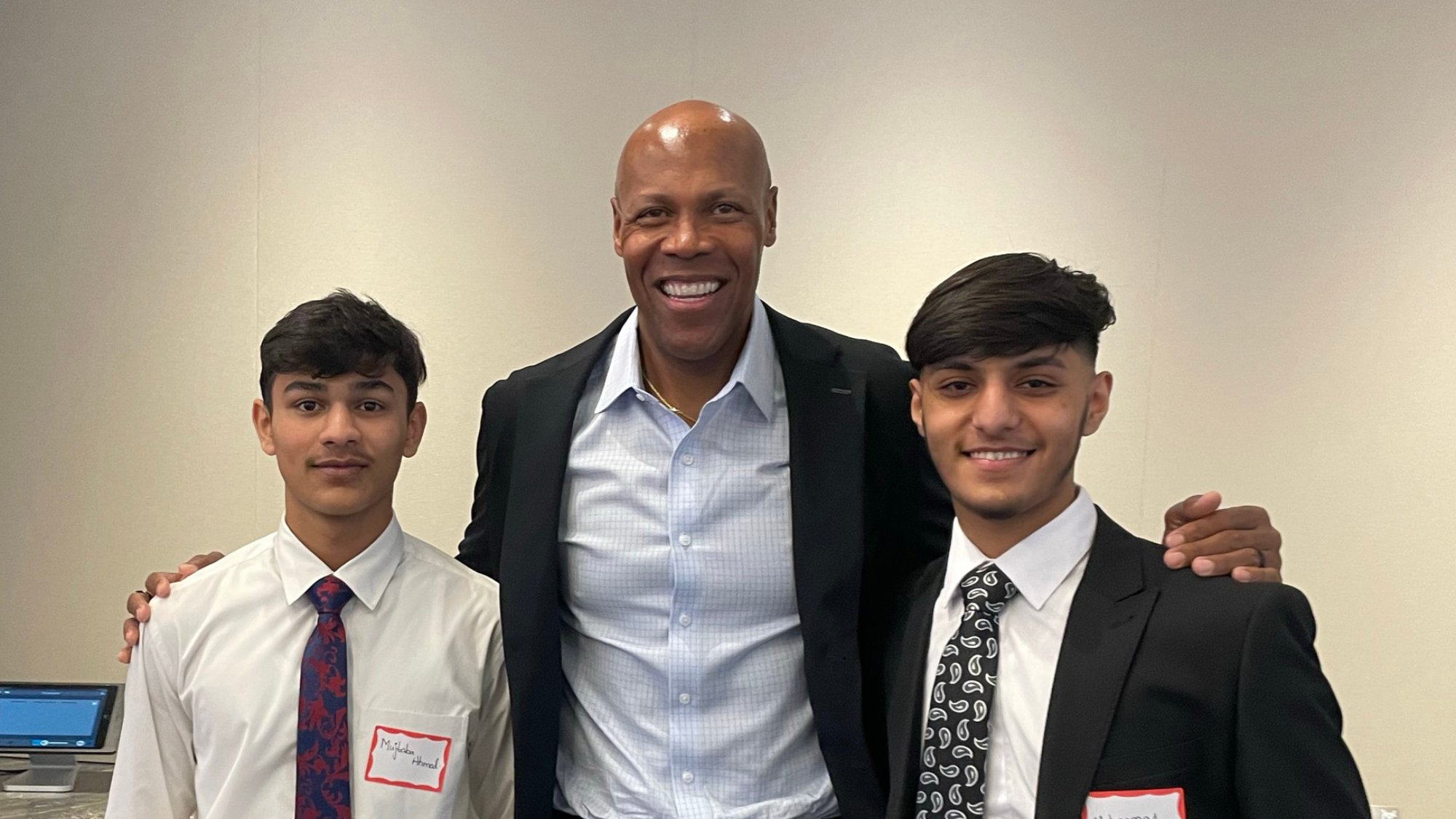 From left: Mujtaba Ahmed; Todd Scott, SVP at Kyndryl; Muhammad Khan. The two 10th-grade students at the Academy of Innovative Technology visited Kyndryl's headquarters with their peers to learn about careers in technology.