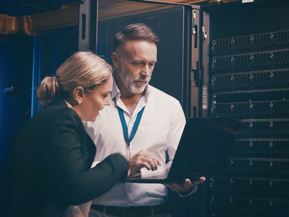Two people working out a project in a data center