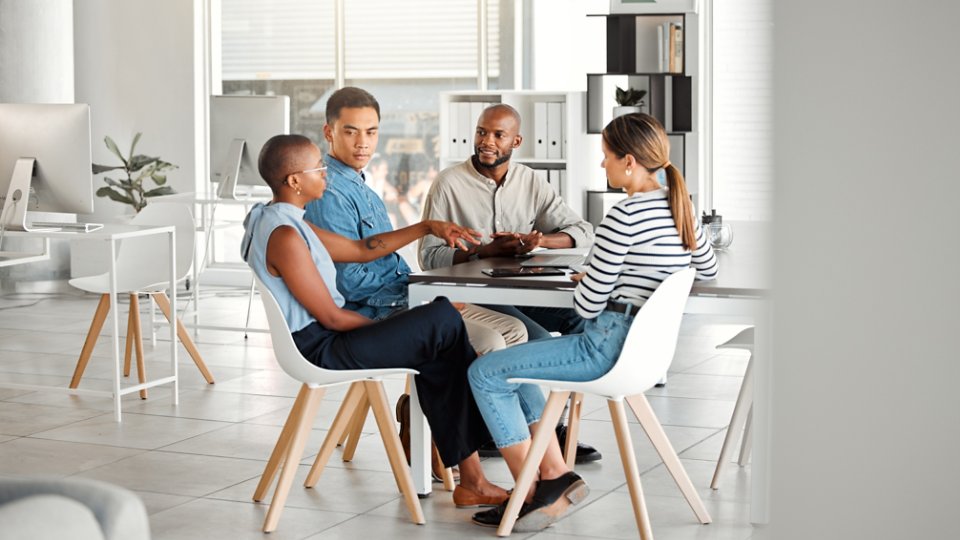 Business people, meeting and diversity in office with digital media management team and chat. Teamwork, conversation and online campaign launch and planning at desk with collaboration at startup.
