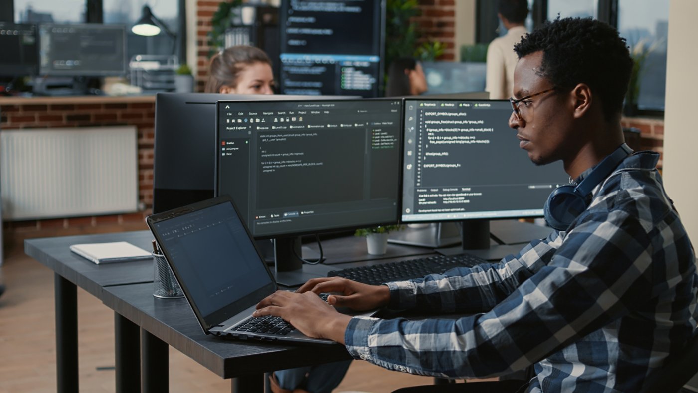 IT professional using multi screen