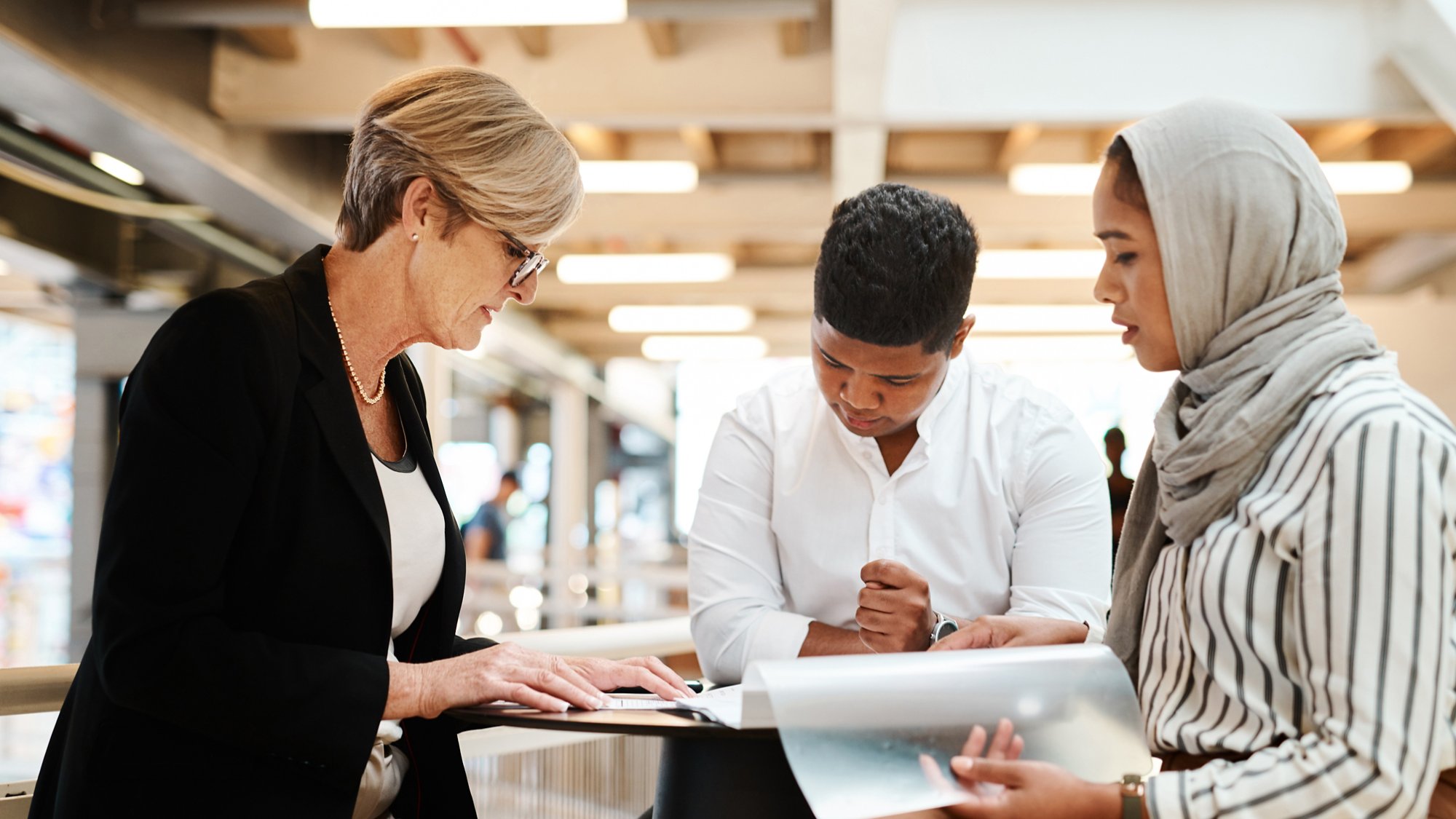 Shot of a group of businesspeople going through paperwork together in an office