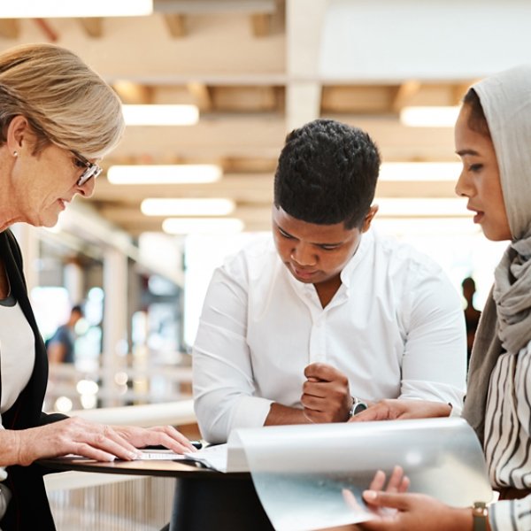 Shot of a group of businesspeople going through paperwork together in an office