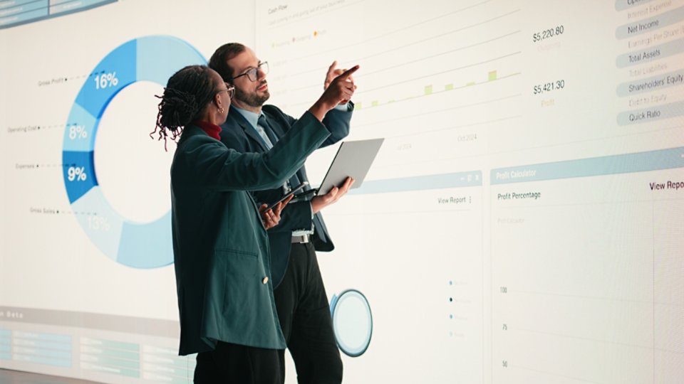 Corporate managers evaluate fiscal performance metrics on digital wall, collaborating, Diverse executive team discusses quarterly earnings report and shareholder equity charts during boardroom.