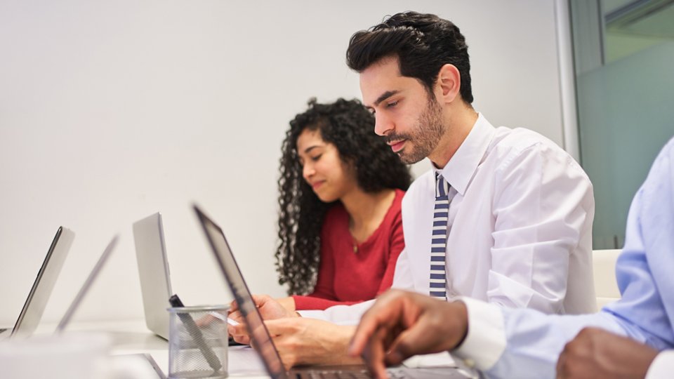 Young business people in a training course in a computer workshop or during e-learning