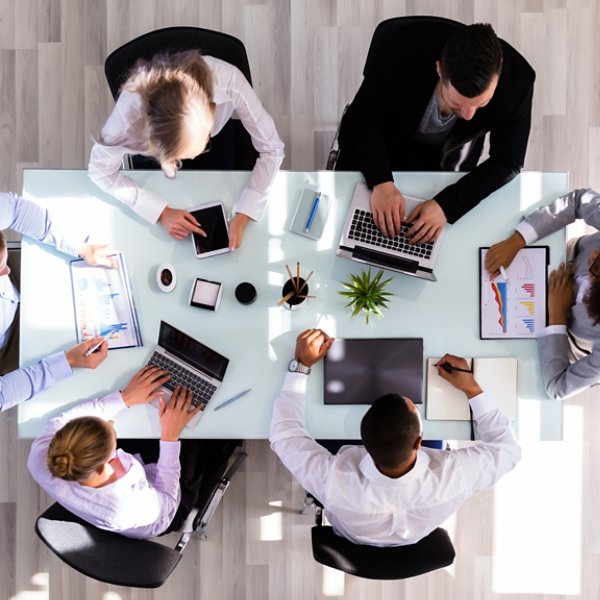 Elevated View Of Businesspeople Working On Graphs In Office