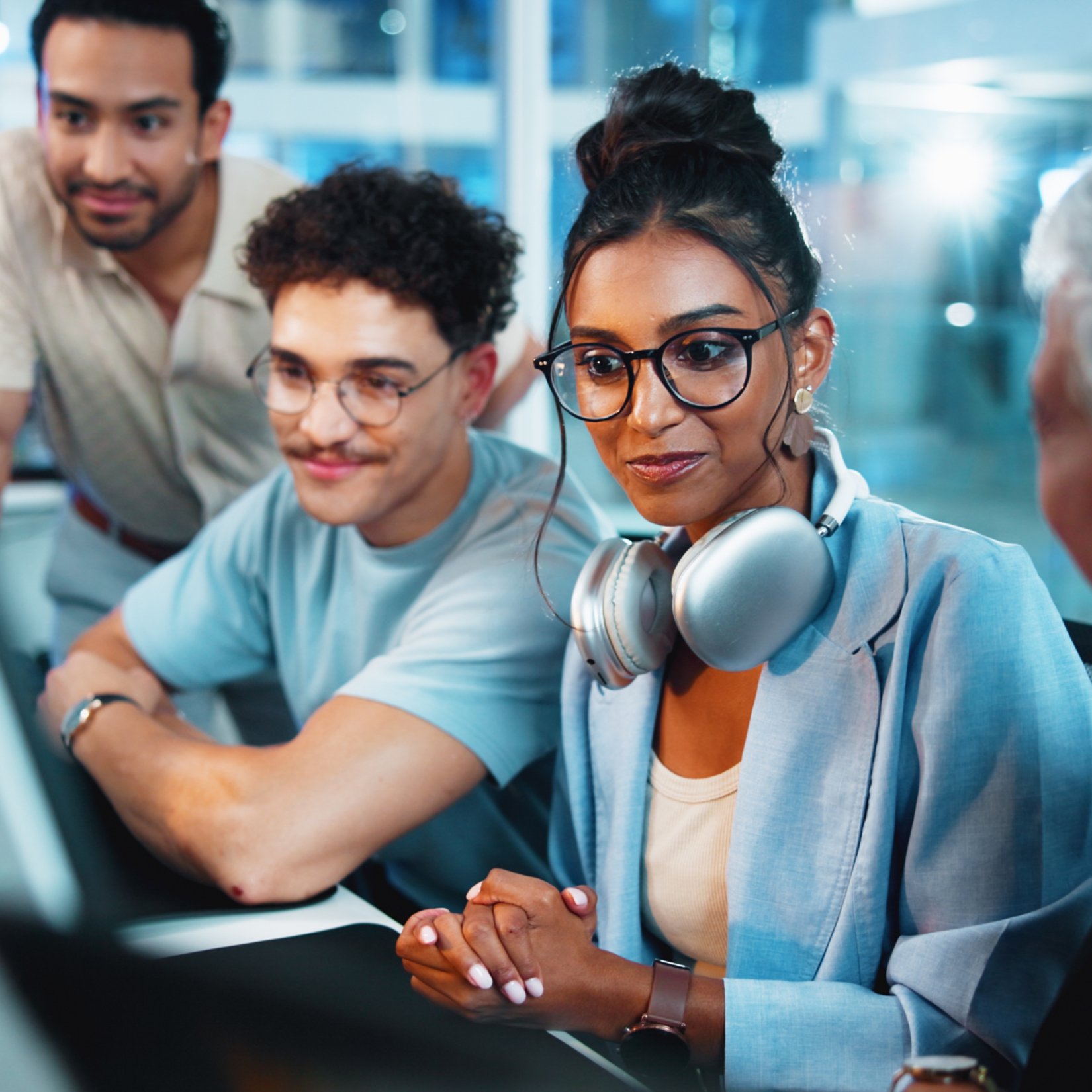 Office, programmer and group with computer, discussion and brainstorming for algorithm on website. Collaboration, colleagues and people with technology for new code, talking and planning with system.