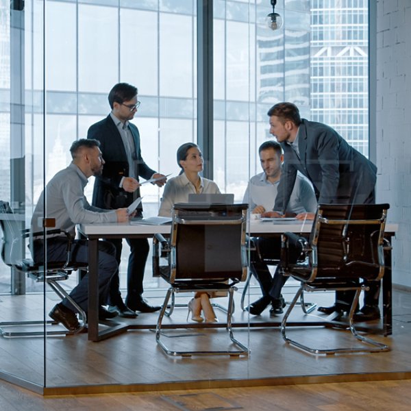 Teamwork: young business people discussing holding a presentation in modern office building