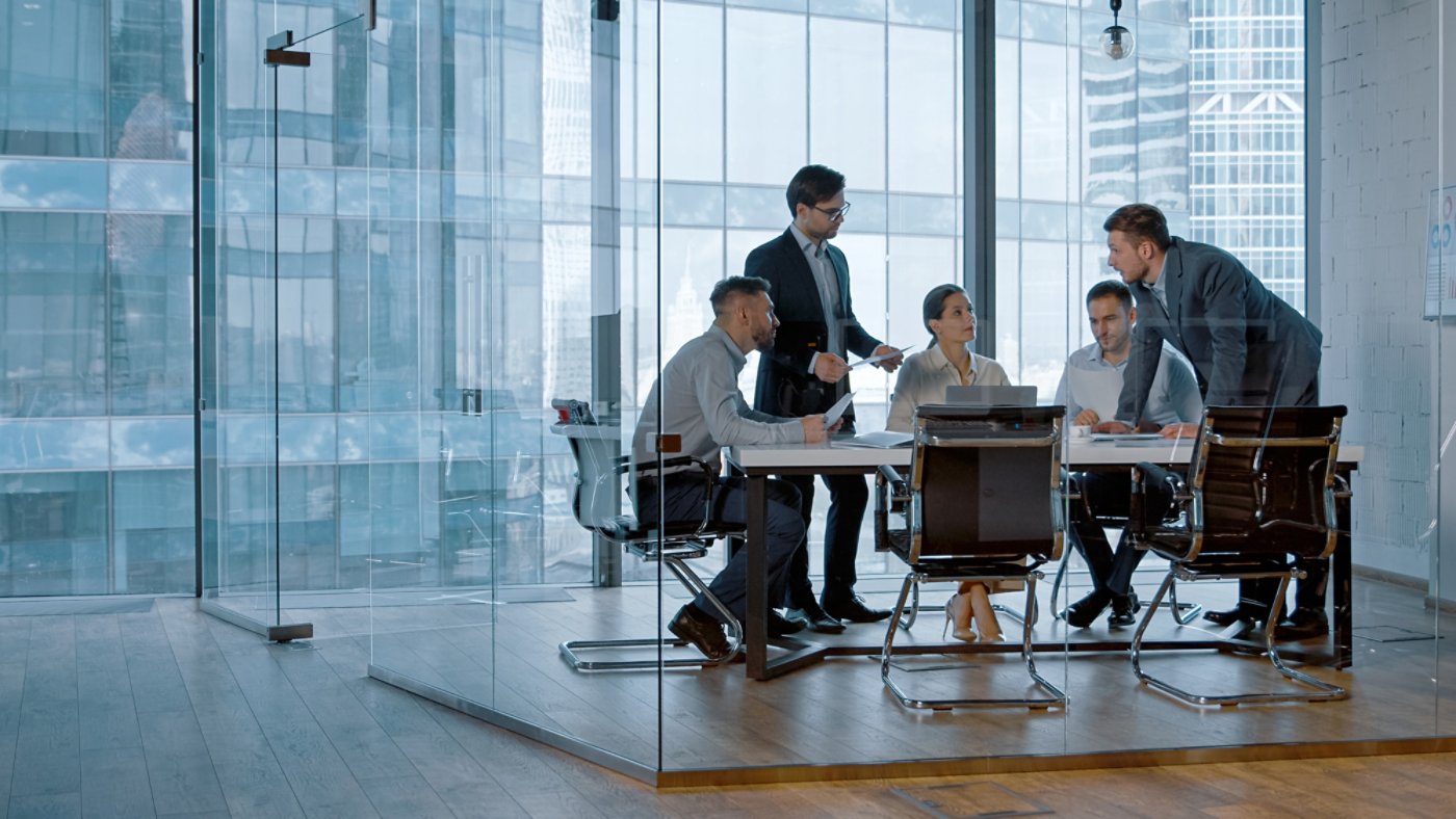 Teamwork: young business people discussing holding a presentation in modern office building