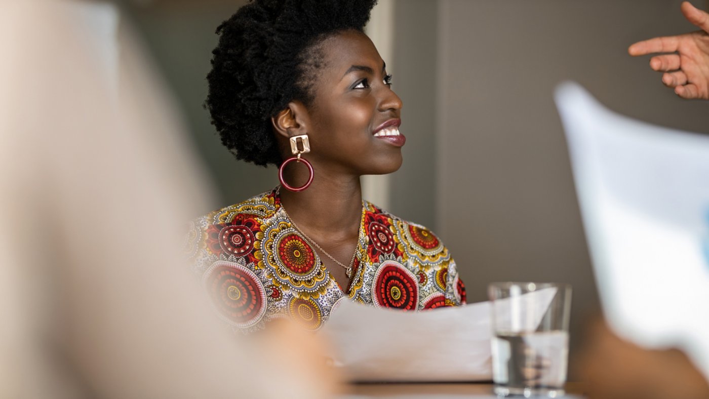 Beautiful young confident professional black african business woman smiling in meeting