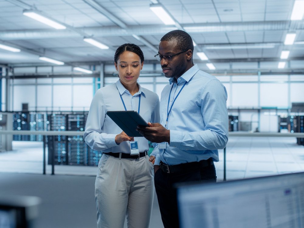 Male and female colleauges looking at a tablet