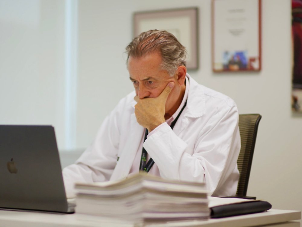 male-doctor-viewing-laptop-in-office