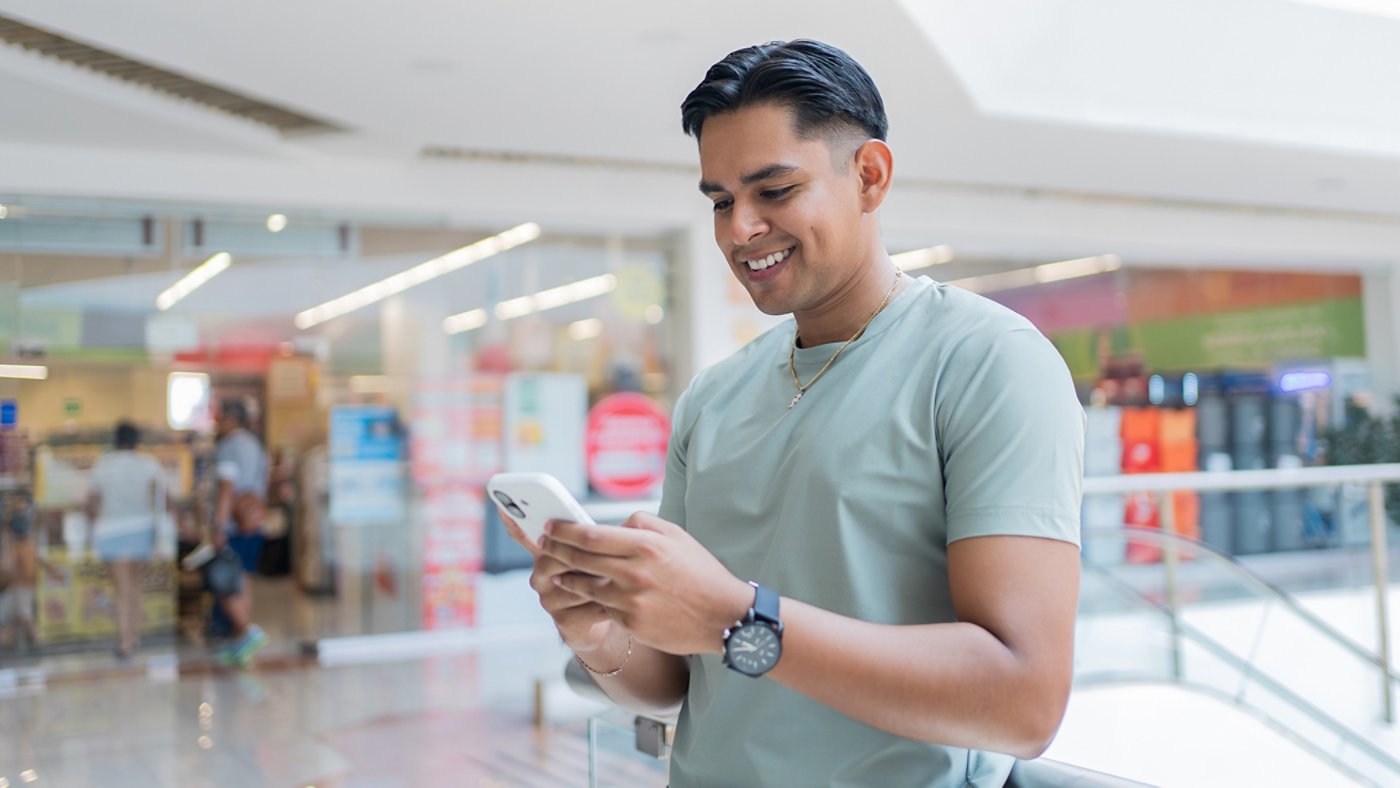 man in a mall on his phone