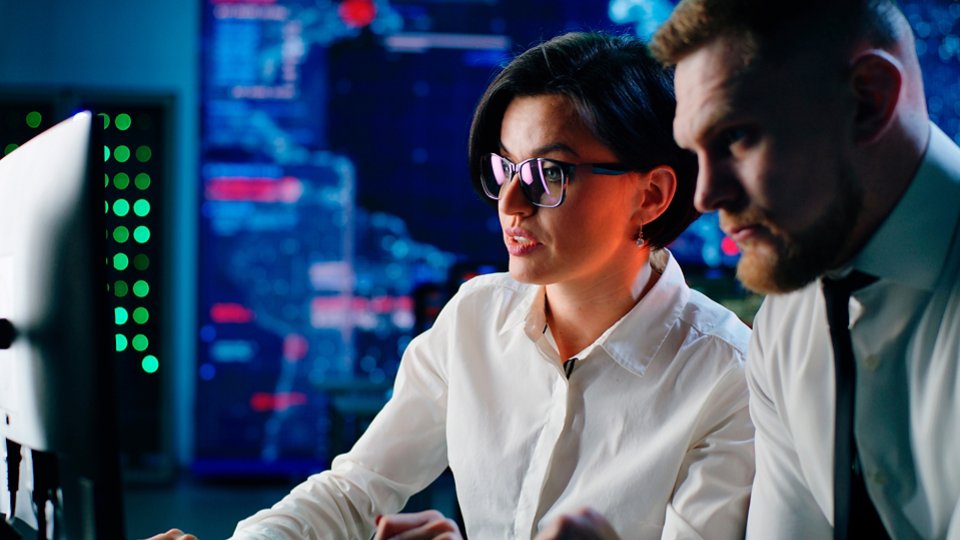 man and woman at workstation