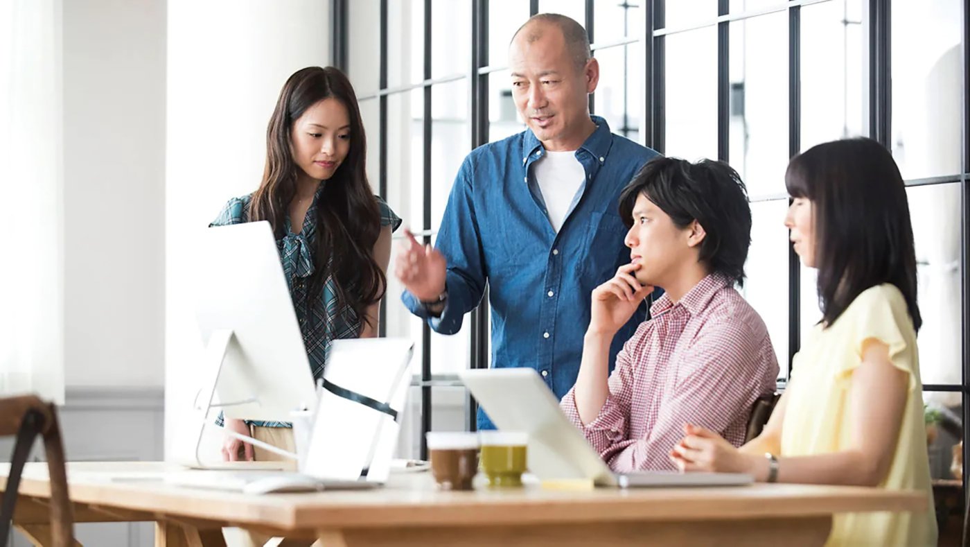 4 people around a computer