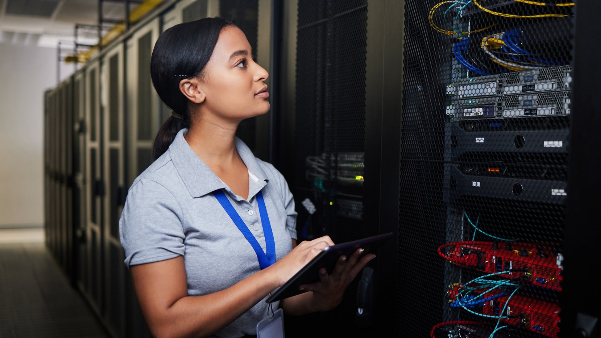 Woman, engineering tablet and server room, data center inspection or system solution for cybersecurity coding. IT person on digital technology, cables check and business power or programming hardware.