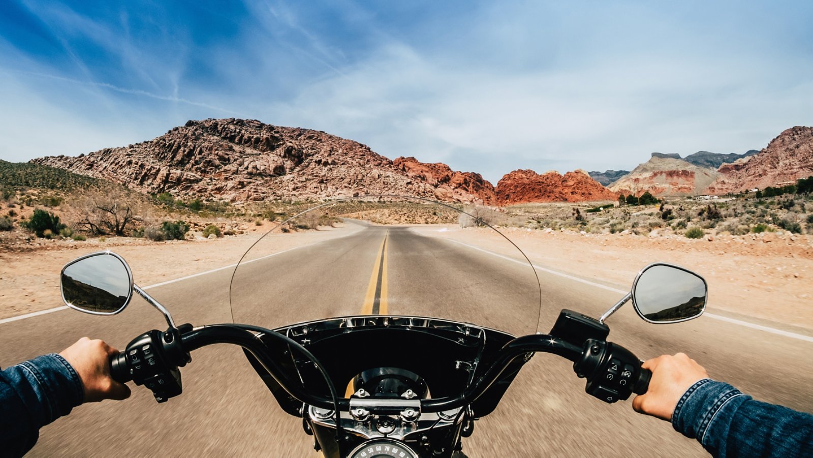 First person view of a man driving a motorcycle on a road